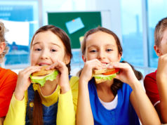 Wzorowy sklepik szkolny – co powinno się w nim znaleźć? Dzieci jedzą zdrowe kanapki
