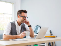 Czy często powtarzane, słynne 21 dni rzeczywiście wystarczą do pozbycia się nawyku? zadowolony młody biznesmen przed ekranem laptopa