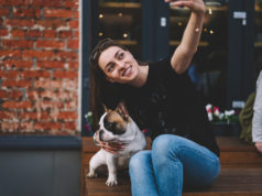 Francuskie podejście do mody i pielęgnacji młoda Francuzka robiąca sobie zdjęcie z psem