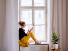 Jakie są najciekawsze premiery książkowe na koniec roku 2021? kobieta czytająca w oknie